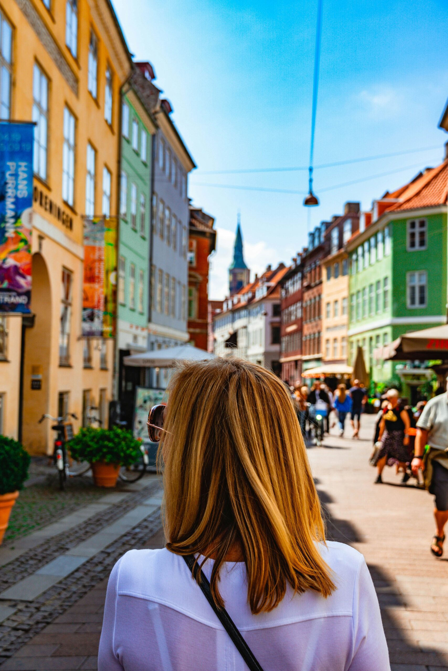 A blonde woman walking in Copenhagen