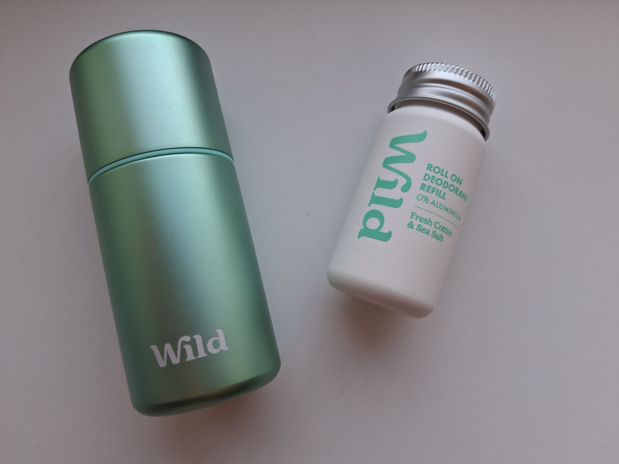 The aqua case for the roll on deodorant and the fresh cotton & sea salt refill.