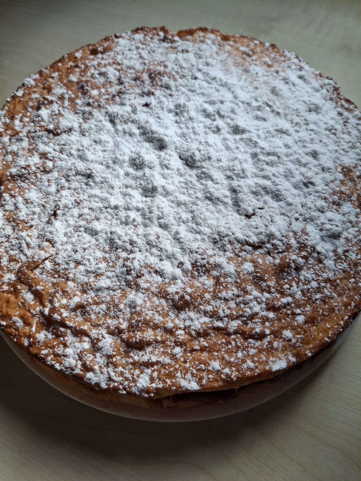 The Victoria Sandwich Cake with raspberry jam filling and topped with powered sugar from The Official Bridgerton Cookbook
